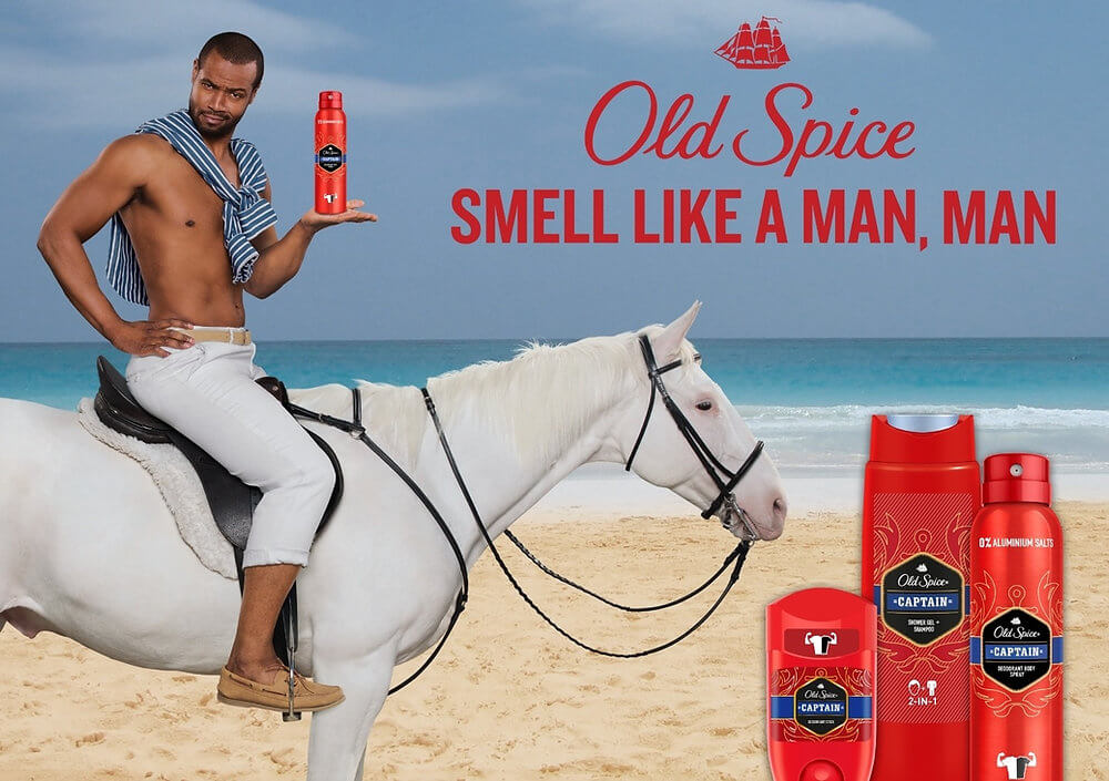 Old Spice actor, Isaiah Amir Mustafa, holding a deodorant while sitting on a white horse