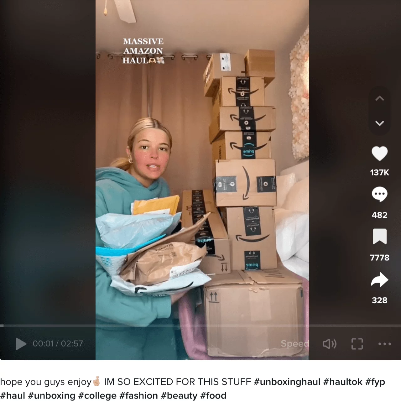 TikTok video of a girl with a tower of delivery packages from Amazon.