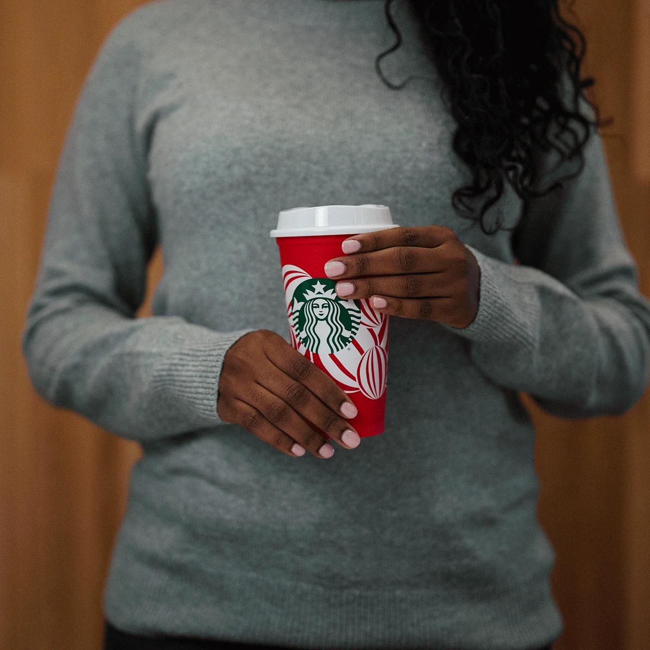 Starbucks reusable red cup giveaway day gif with the same Christmas red cup but only changing the looks of the girl that holds it