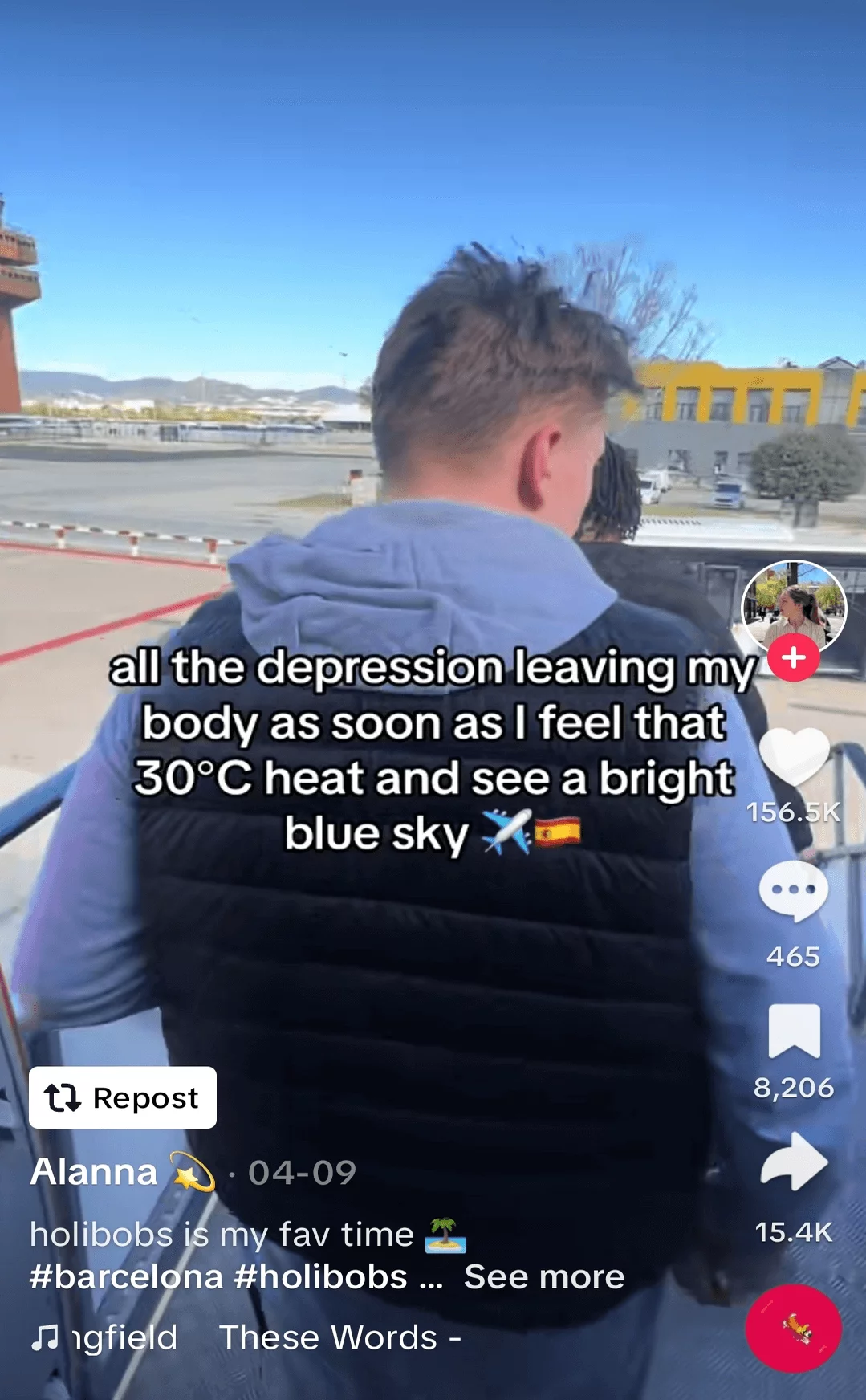 Man viewed from behind, looking out over a sunny airport runway, featured in a social media post expressing relief and enjoyment of warm weather.