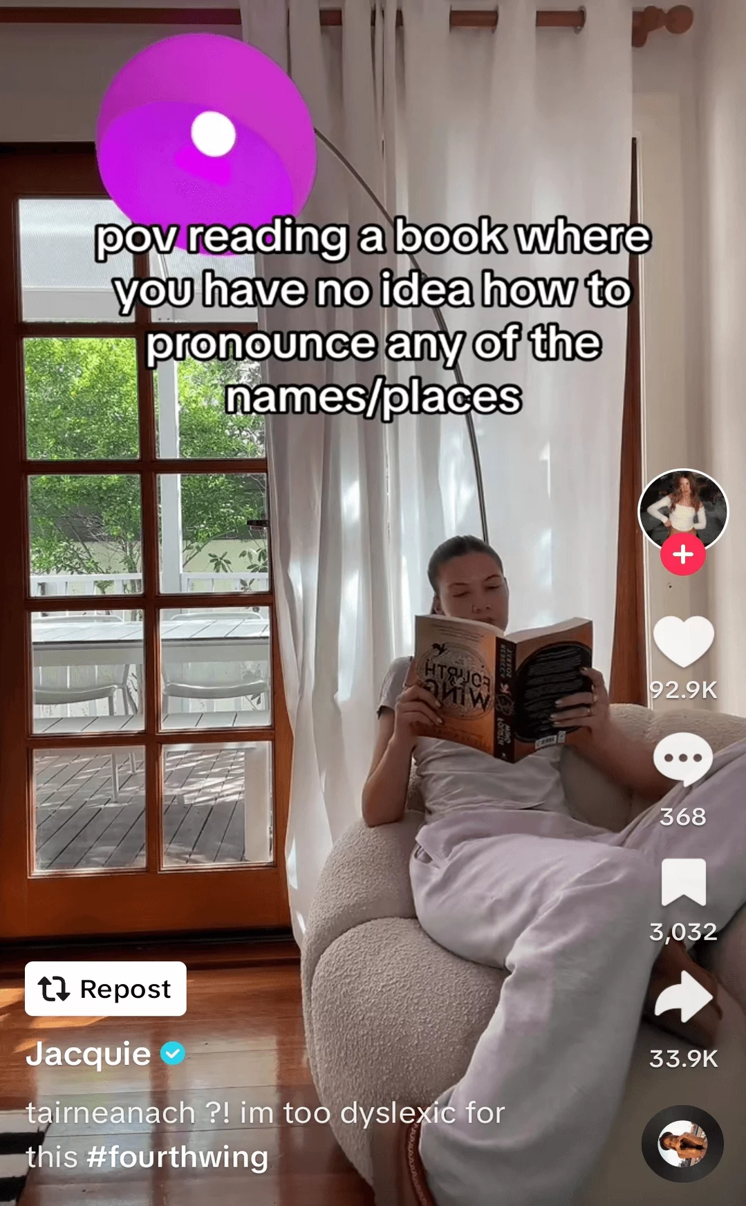 Woman relaxing in a cozy nook by a window, deeply engaged in reading a book, depicted in a social media post.