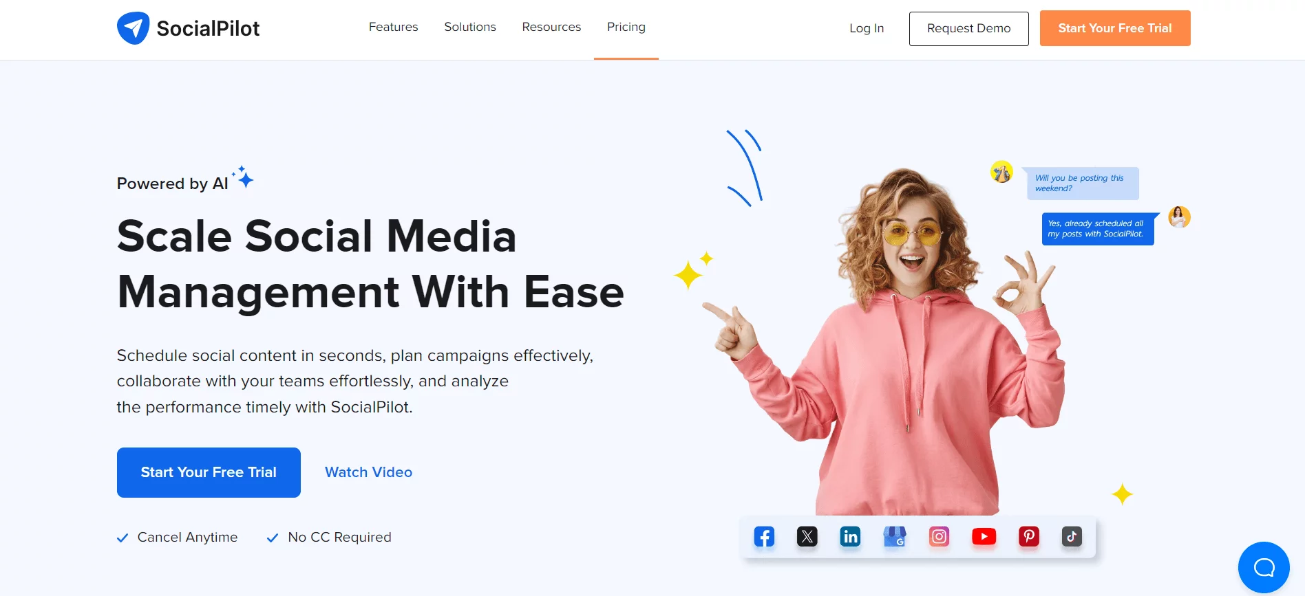 Homepage of SocialPilot highlighting AI-powered social media management tools, featuring a joyful woman pointing upwards, with options to start a free trial or watch a video demo.