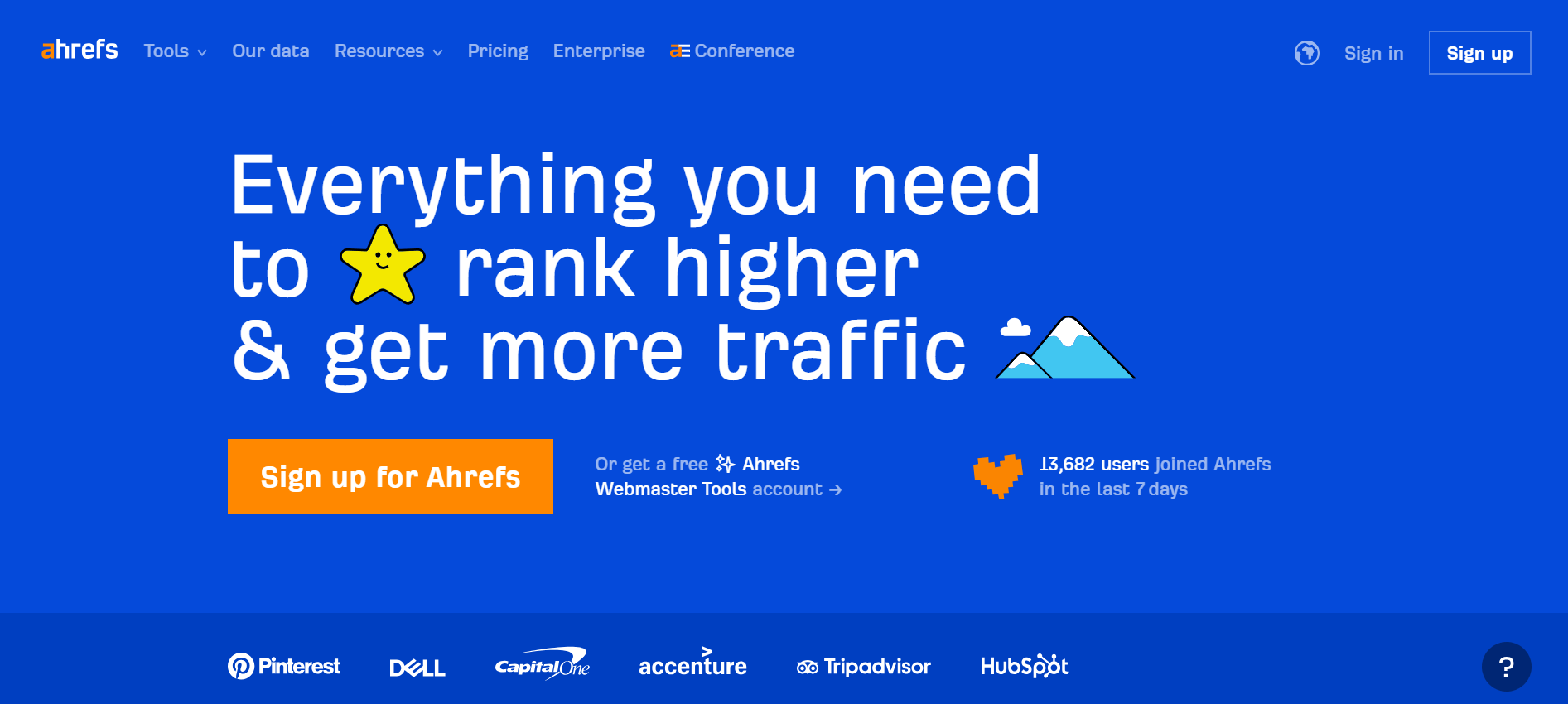 Ahrefs homepage banner promoting its SEO tools with bold text emphasizing ranking higher and increasing traffic, alongside playful star and mountain icons.