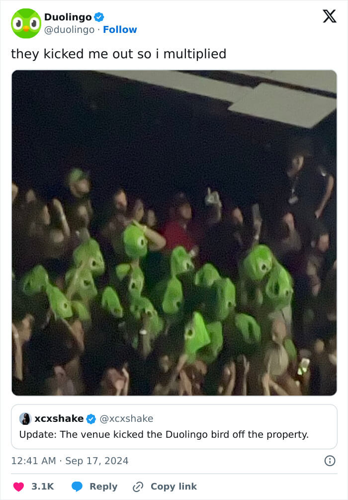 Duolingo's X post showing a crowd of people wearing green Duolingo bird costumes at an event after being reportedly removed by the venue.