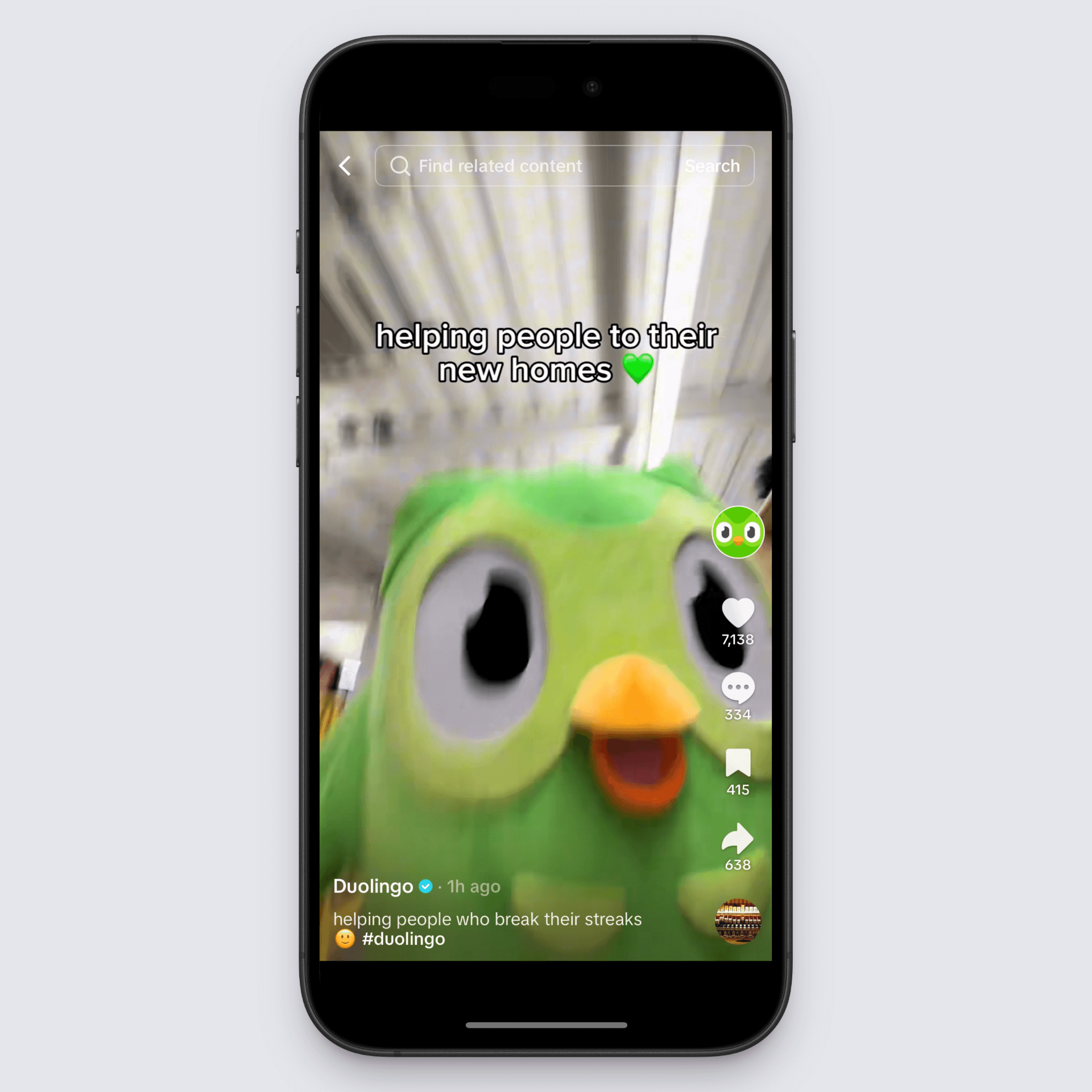 Duolingo mascot Duo close-up with caption “helping people to their new homes” in a TikTok-style video.