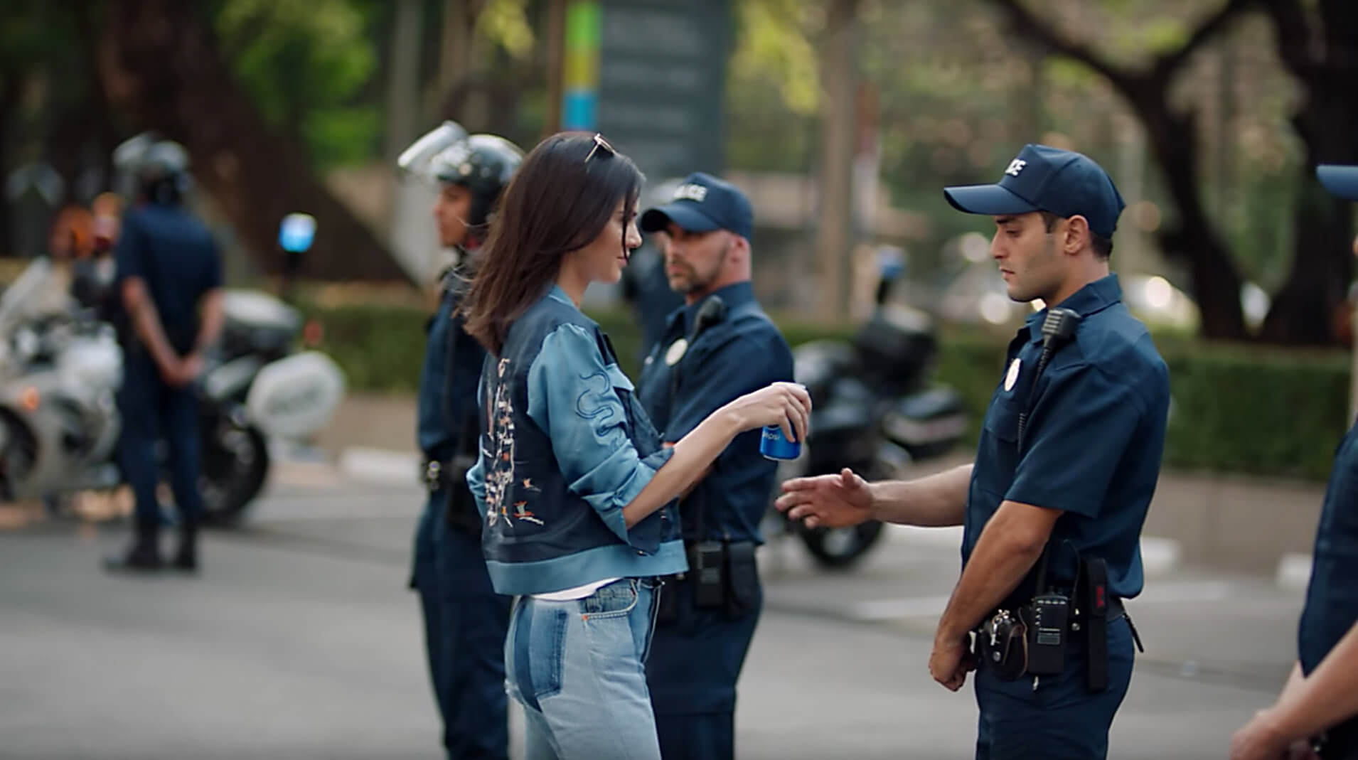 Kendall Jenner hands Pepsi to a police officer during protest in a controversial Pepsi ad scene.