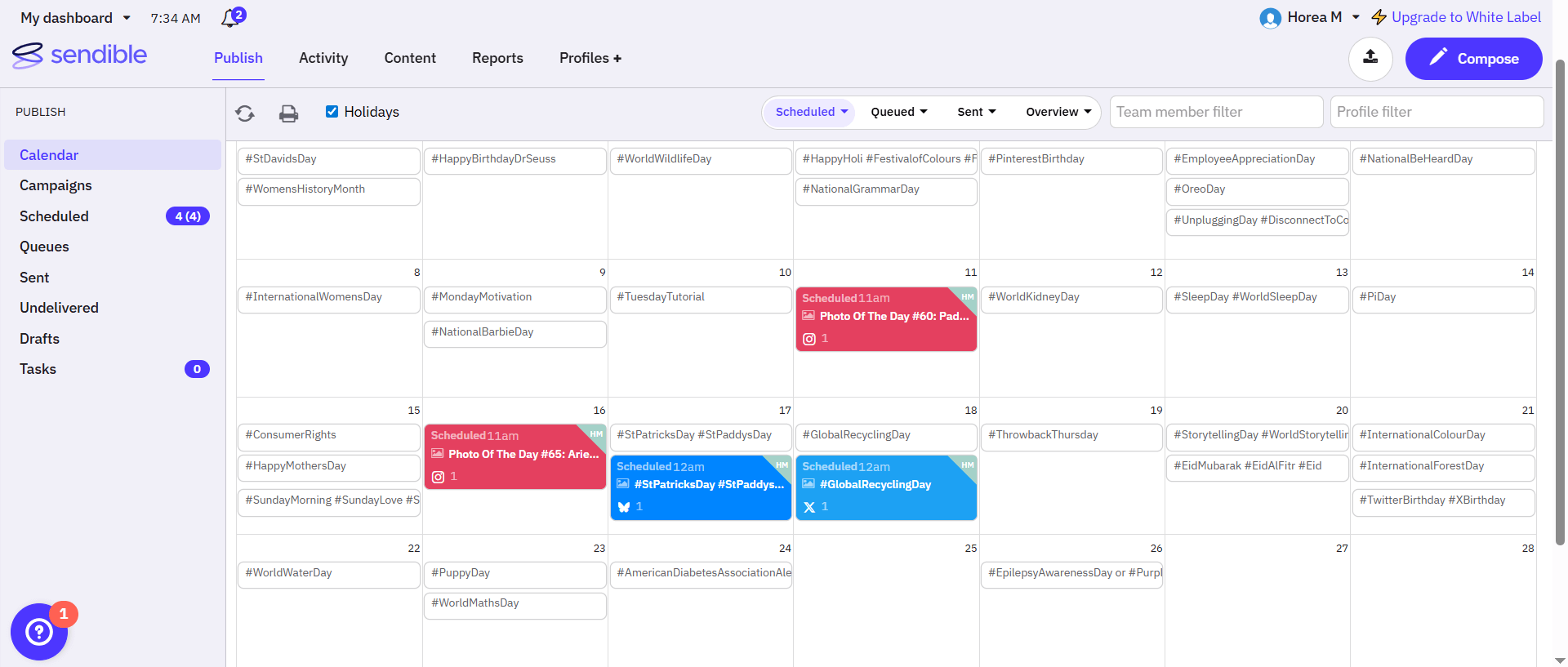 Sendible calendar with scheduled posts and holiday hashtag ideas
