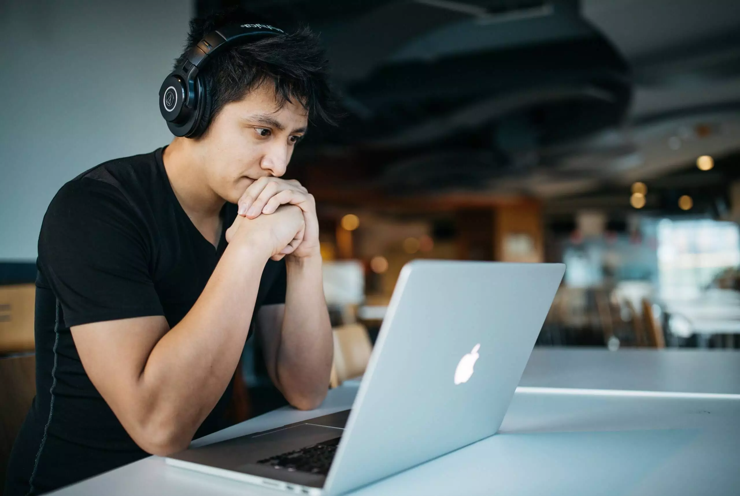 content marketing mistakes - man working on a laptop with headphones