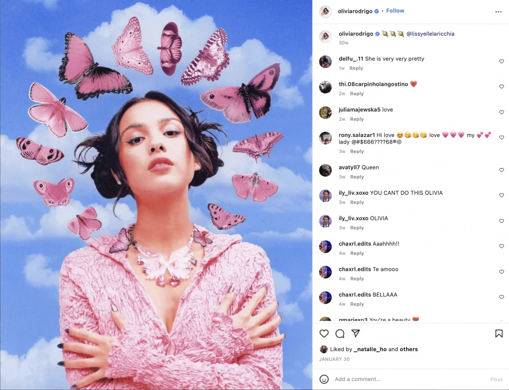 Singer Olivia Rodrigo illustrated with pink butterflies flying around her
