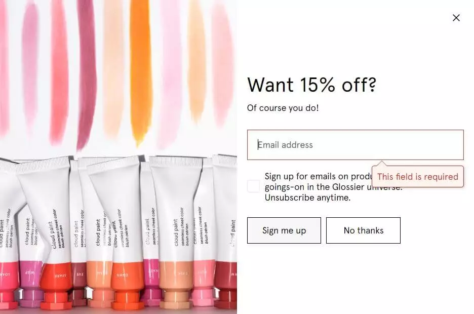 Glossier's offering 15% off. An email sign-up form with a 'Sign me up' and 'No thanks' option is displayed, highlighting a 15% discount in exchange for subscribing to Glossier emails.