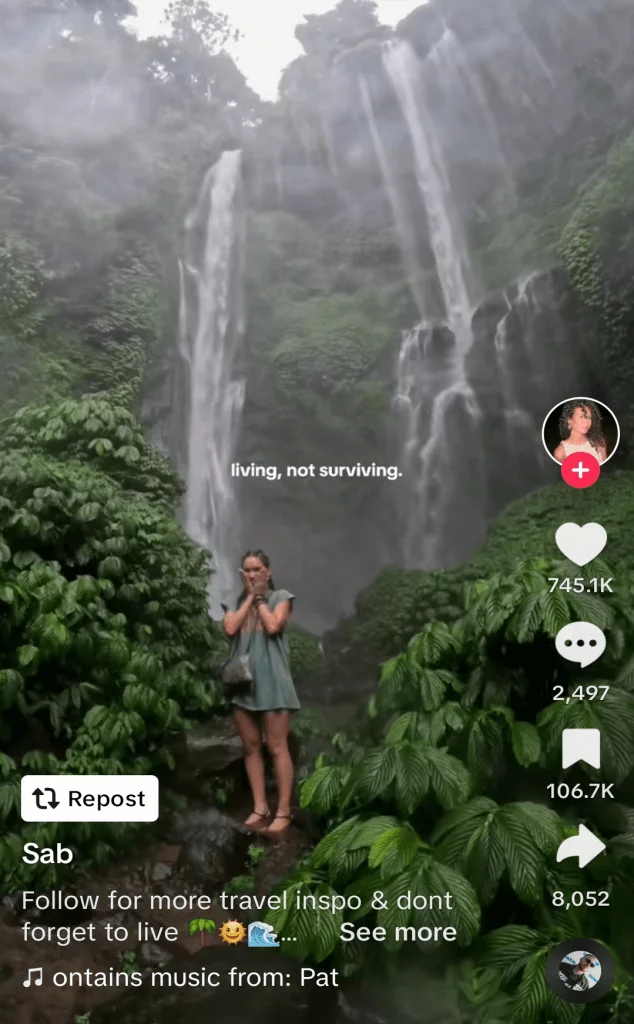 TikTok post of a woman in a rainforest with waterfalls behind her, captioned 'living, not surviving'.