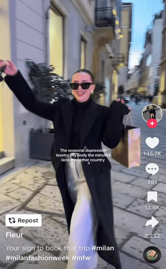 TikTok post of a woman dancing in the street in fashionable clothing, captioned 'the seasonal depression leaving my body the minute I land in another country'.