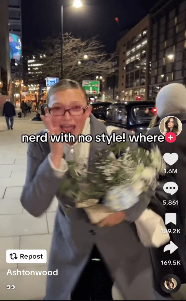 TikTok post of a surprised woman turning to the camera, captioned 'nerd with no style! where?'