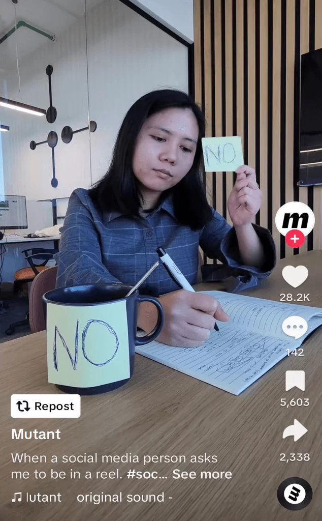 TikTok post of a woman holding up a sign that says 'No' when asked a question.