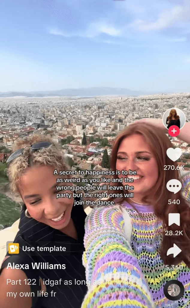 TikTok post of two women on holiday with a cityscape and blue sky behind them