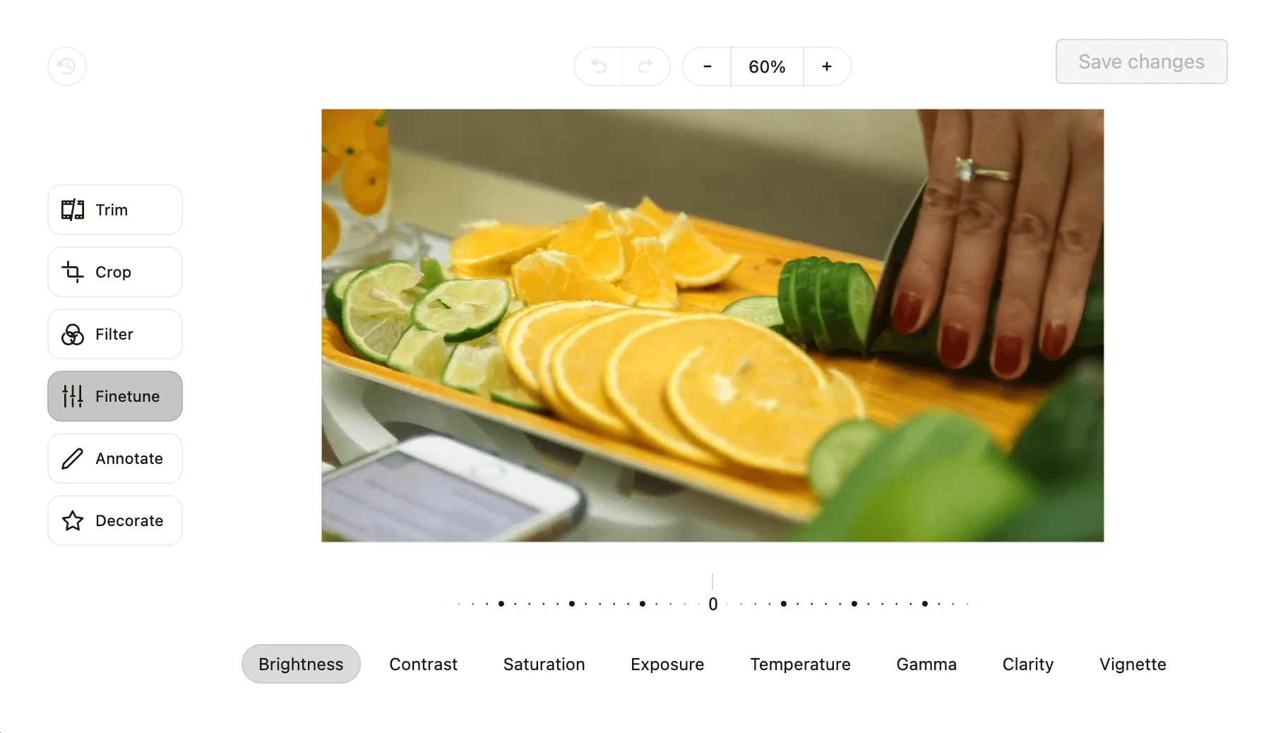 Video editing interface in Planable with tools like crop and filter, showing a person slicing citrus fruits on a cutting board.