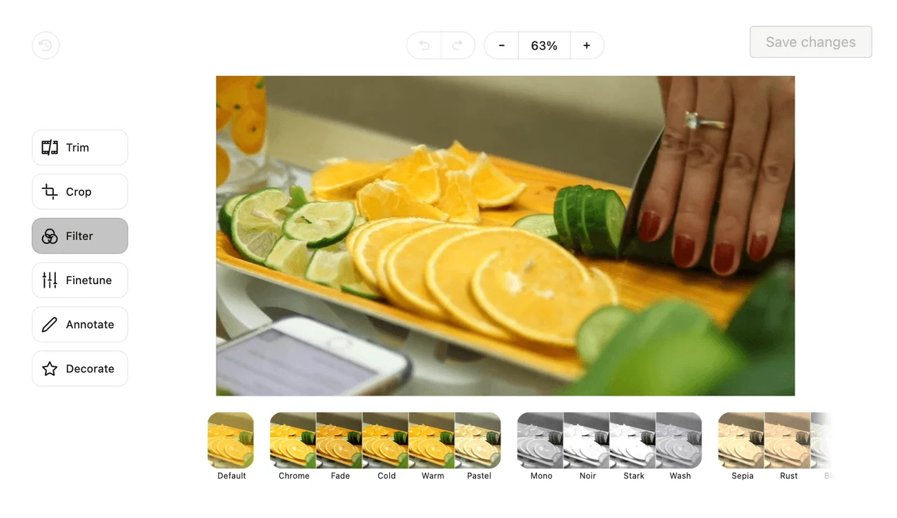 Video editing interface in Planable showing a hand slicing cucumbers on a cutting board with oranges and limes, with filter options at the bottom.