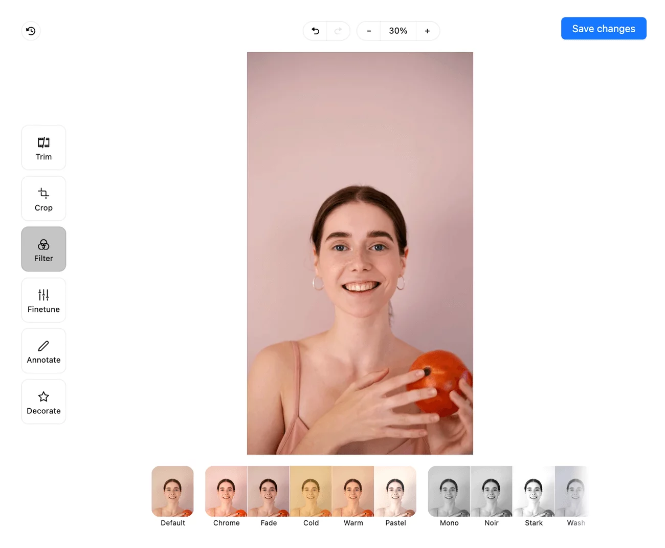 Image editor interface in Planable showing a woman holding a fruit, with filter options like Chrome, Fade, and Warm, and editing tools on the left.