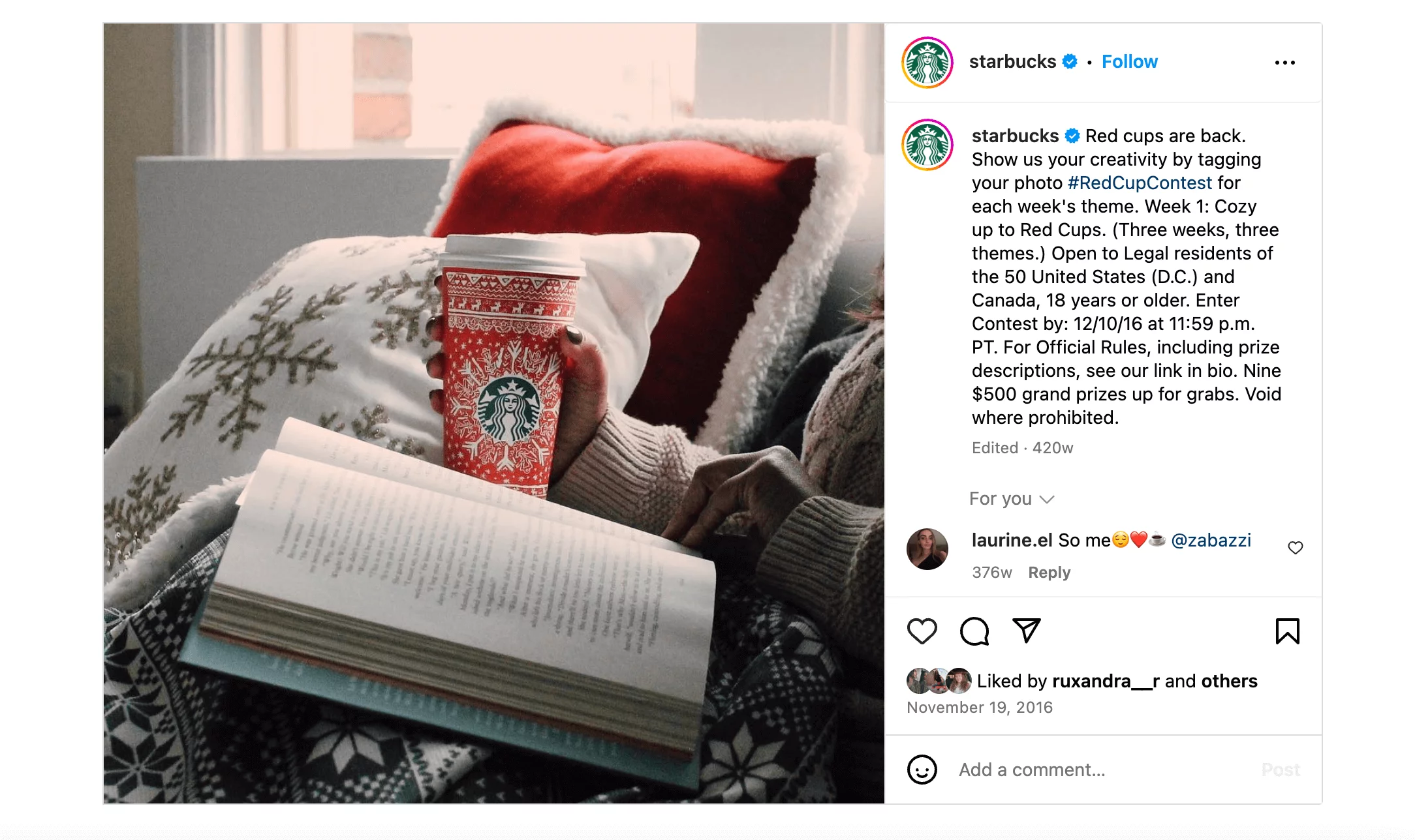 A cozy scene featuring a person holding a Starbucks red holiday cup while reading a book, promoting the #RedCupContest.