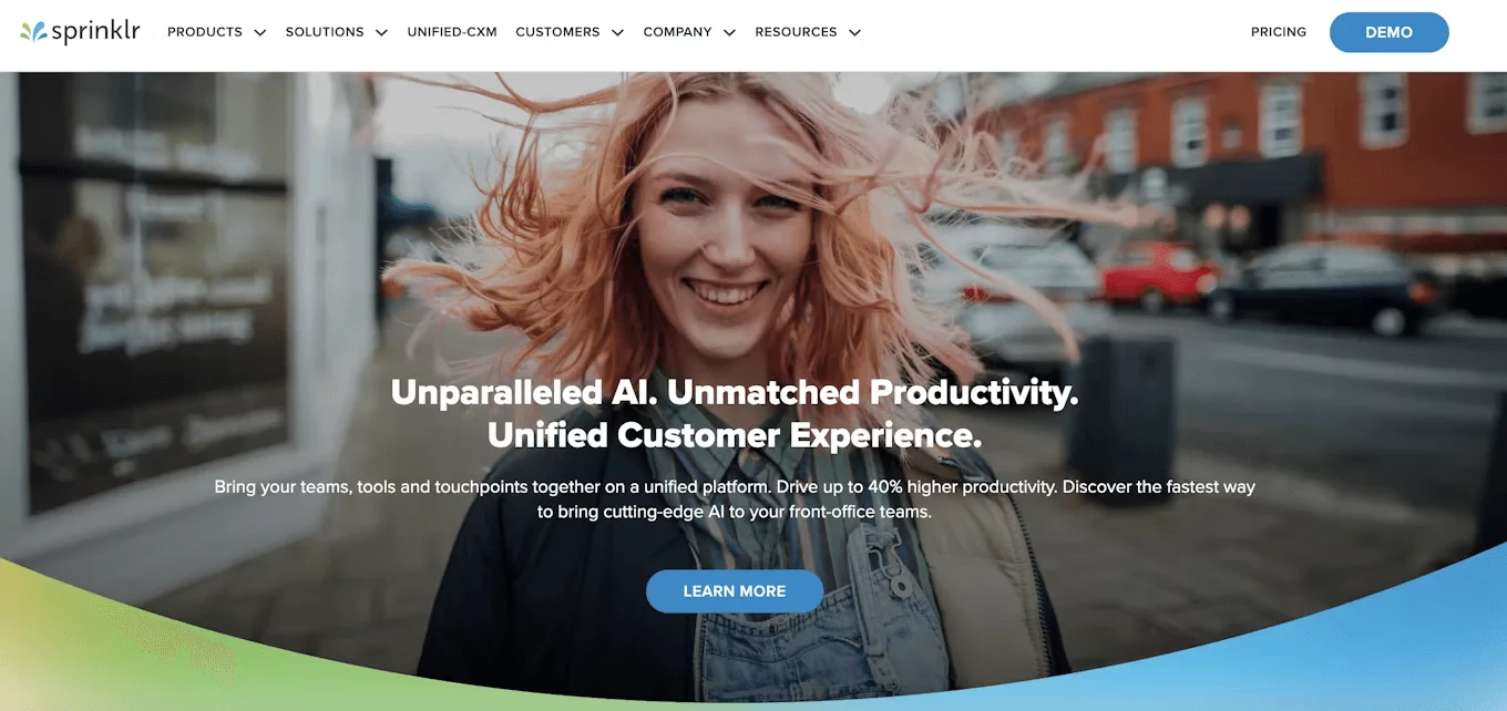 Sprinklr homepage with smiling woman outdoors and tagline promoting AI-powered productivity.